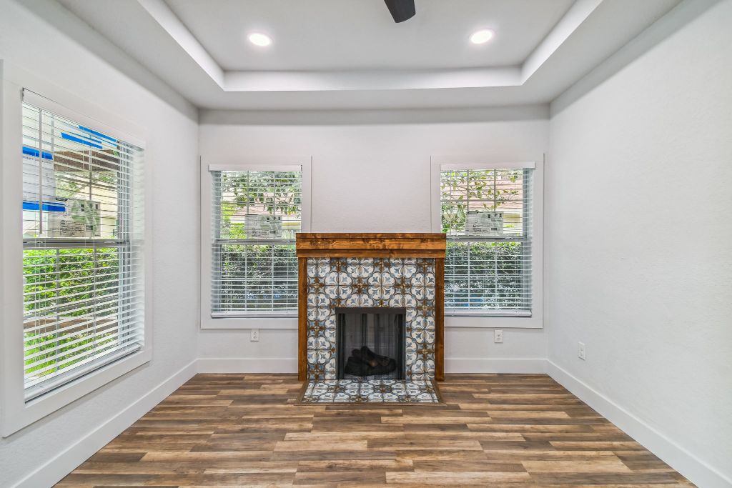 Baker Ave fireplace — encaustic tile surround with reclaimed wood mantel