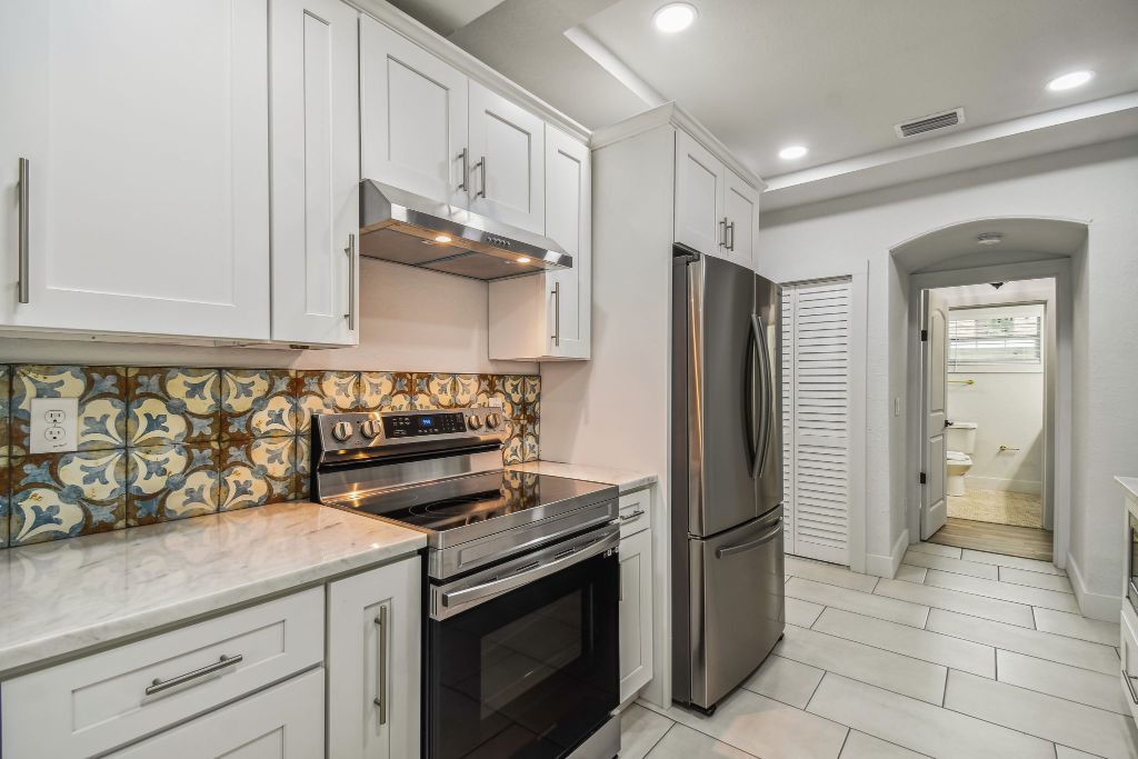 Baker Ave kitchen — encaustic tile backsplash with stainless appliances