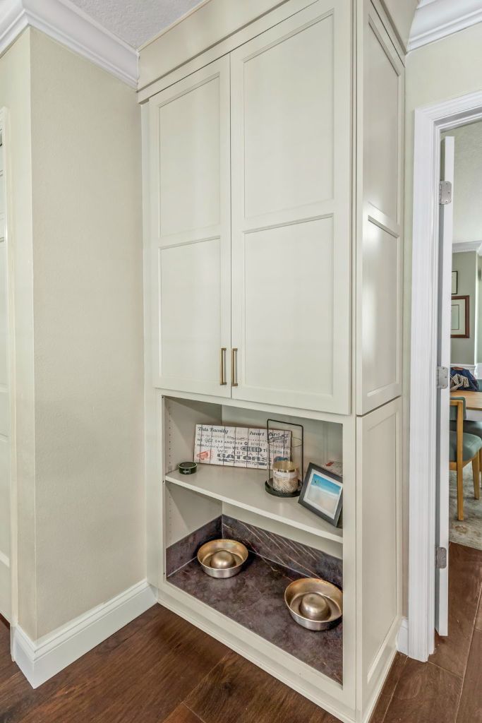 Built-in cabinetry with open shelving and pet feeding station